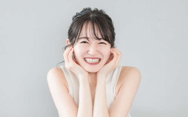 白い歯が美しい笑顔のアジア人女性